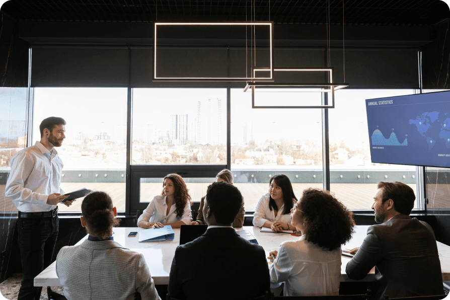 Leadership team reviewing regulatory and financial data in a boardroom